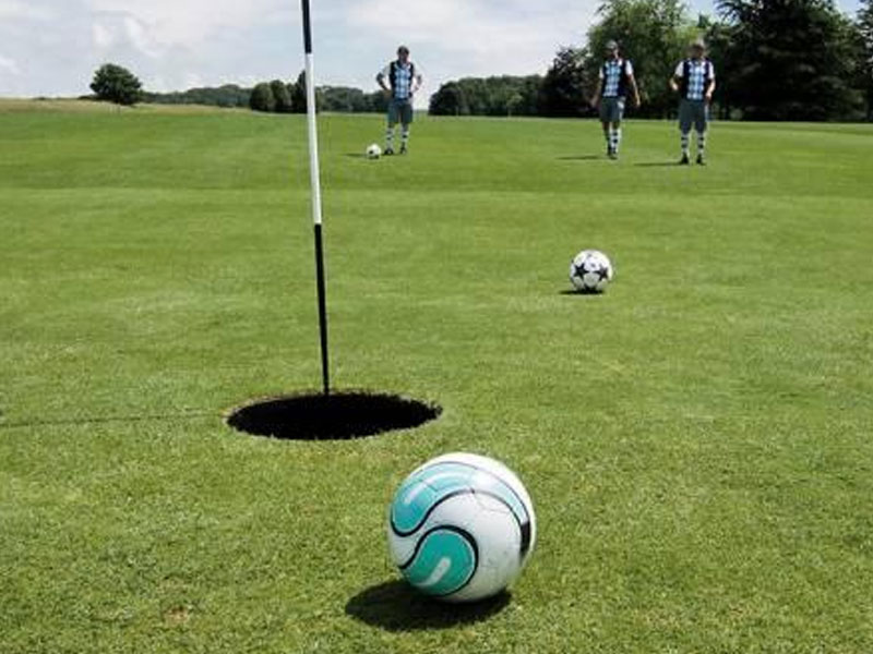 Foot Golf players line up shots toward the cup on the course at Green Tree Golf Club.