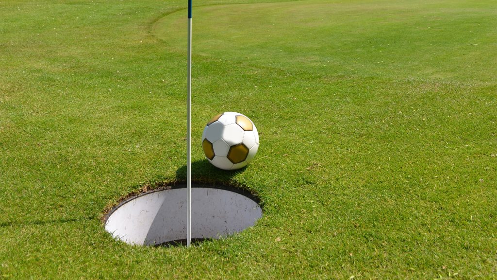 Foot Golf ball near the cup on a green at Green Tree Golf Club in Victorville, CA.