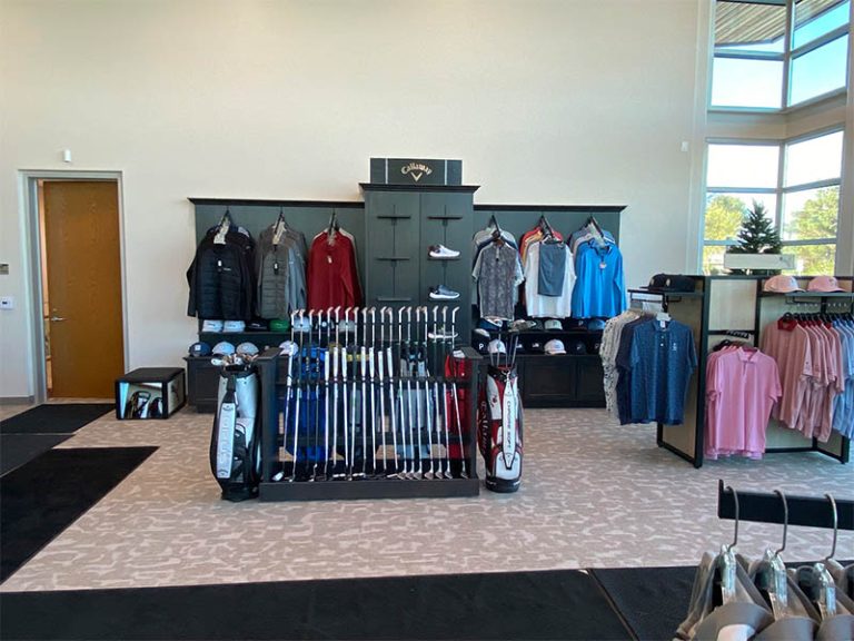 Golf apparel, clubs, and merchandise inside the Green Tree Golf Club pro shop.
